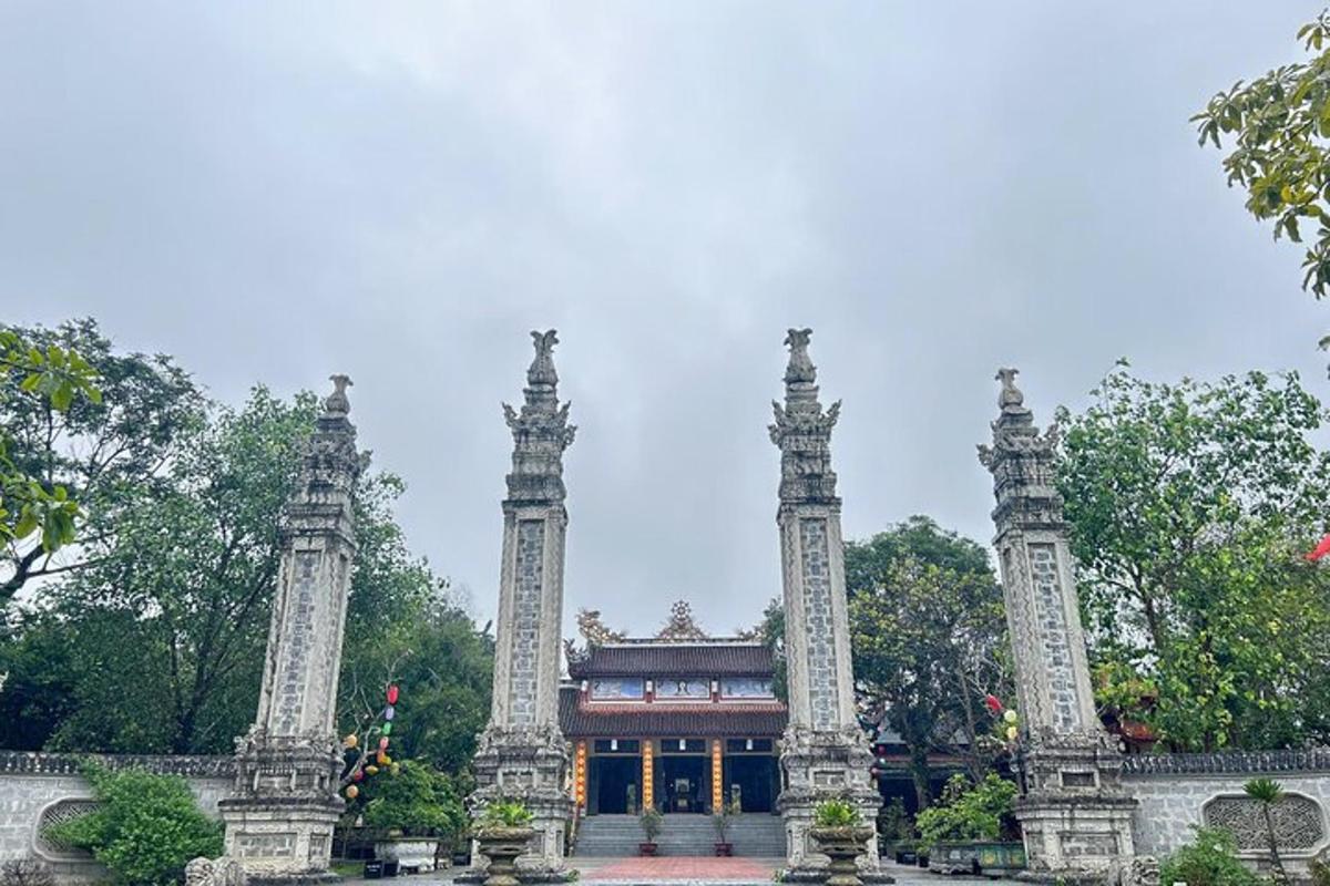 a temple with two tall pillars in front of a building