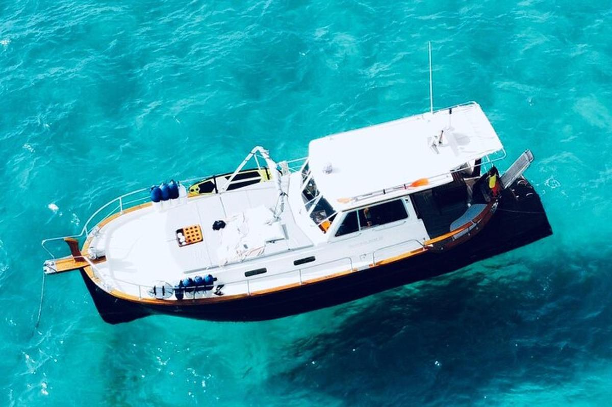 a white boat floating in the blue water