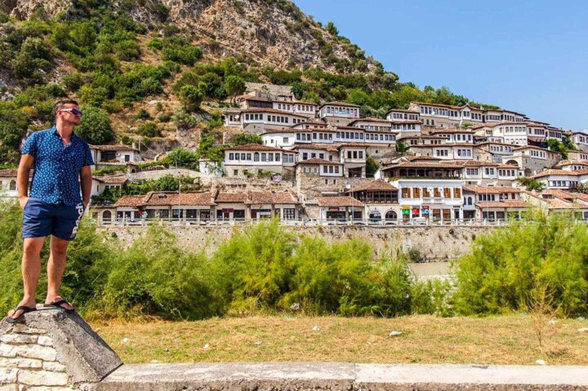 un uomo in piedi su una sporgenza di fronte a una montagna