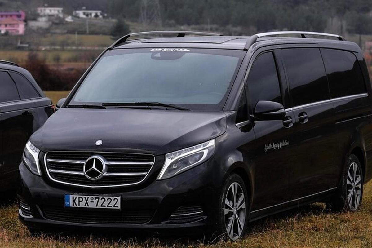 a black mercedes benz van parked in a field