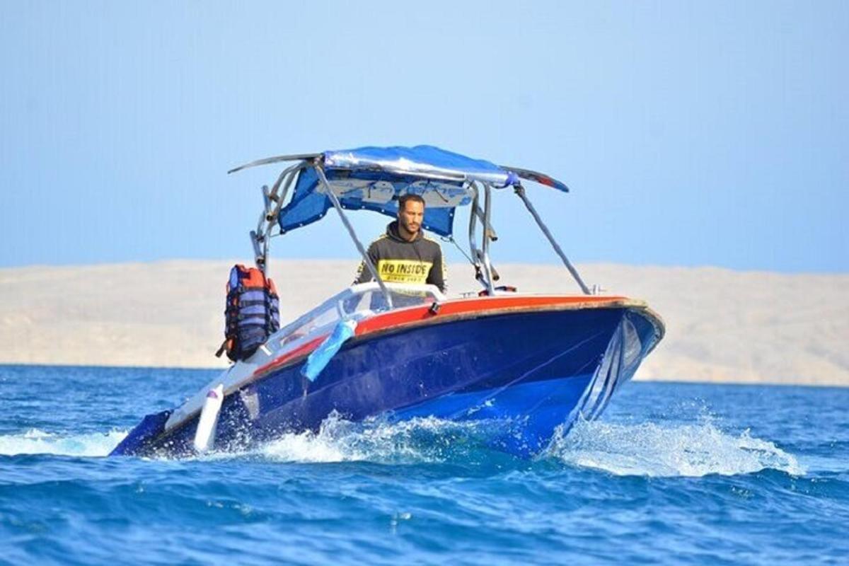 a man in a blue boat in the water