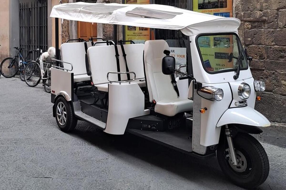en liten hvit golfbil parkert på en gate