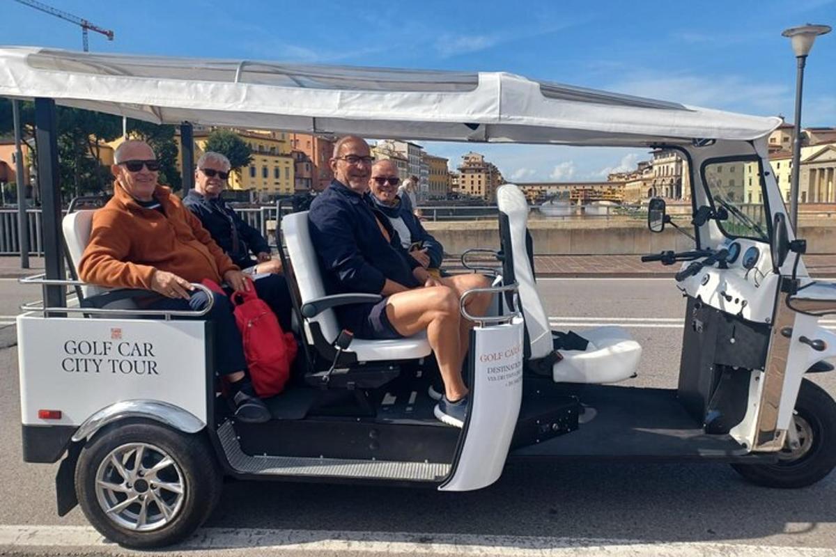 en gruppe menn som kjører en golfbil-bytur