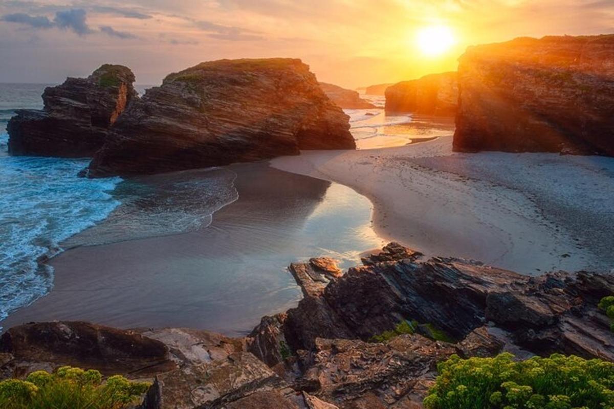 an aerial view of a beach at sunset