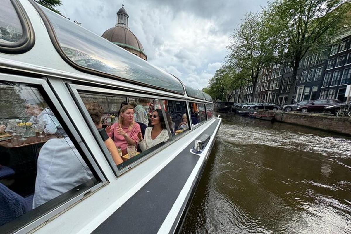 a group of people riding on a boat on a canal