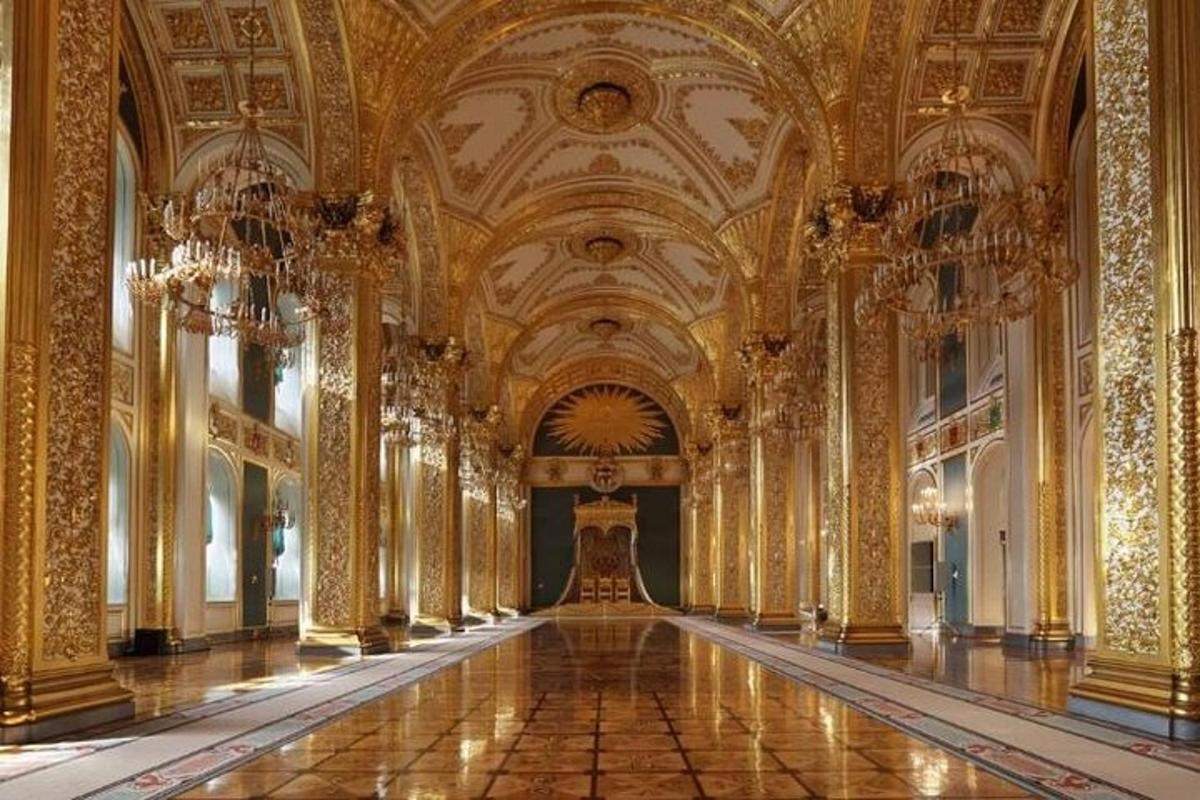 a large room with gold walls and ceilings with a long hallway