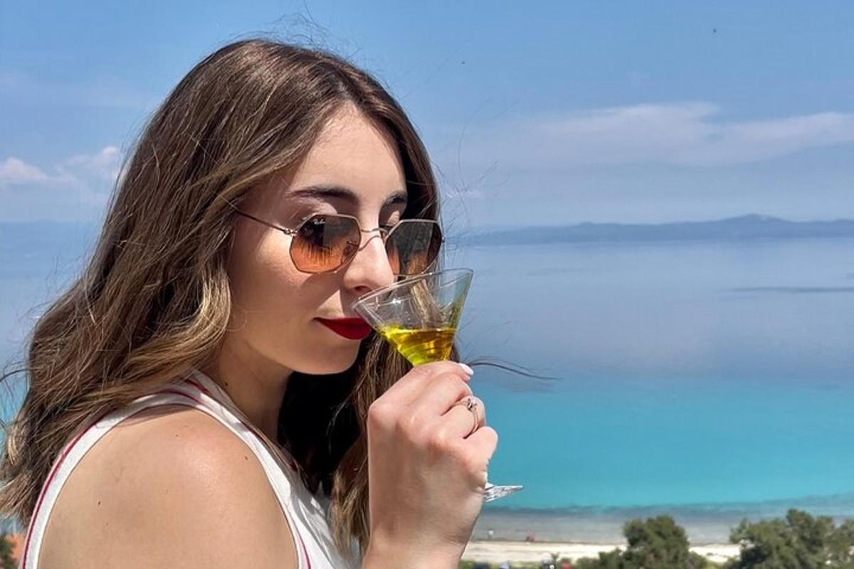 a woman wearing sunglasses holding a wine glass