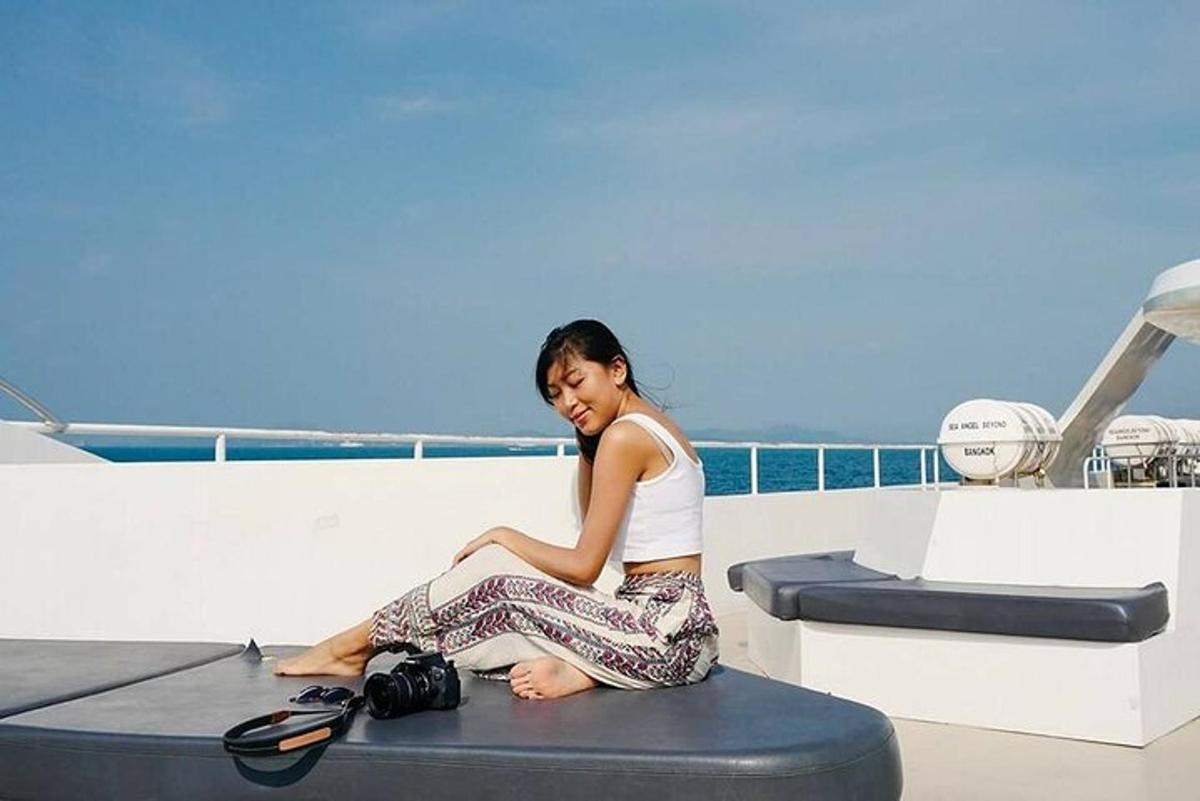 a woman sitting on the edge of a boat