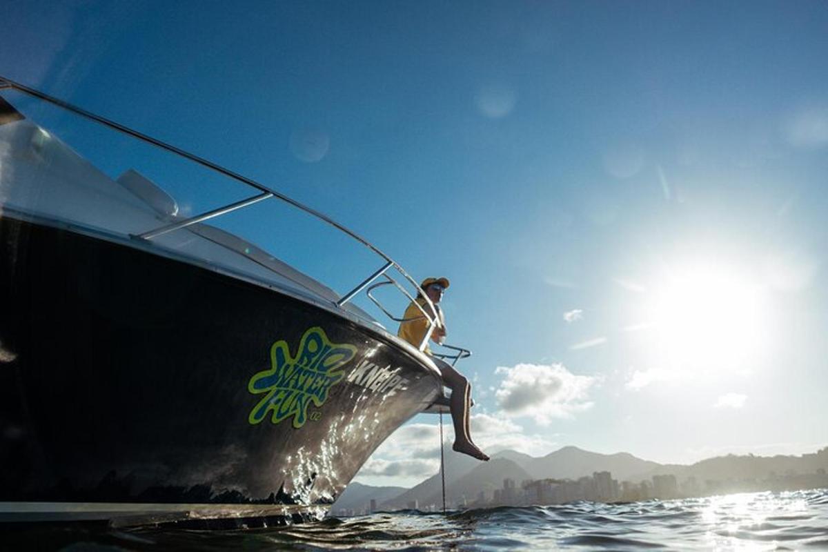 a man sitting on the front of a boat in the water