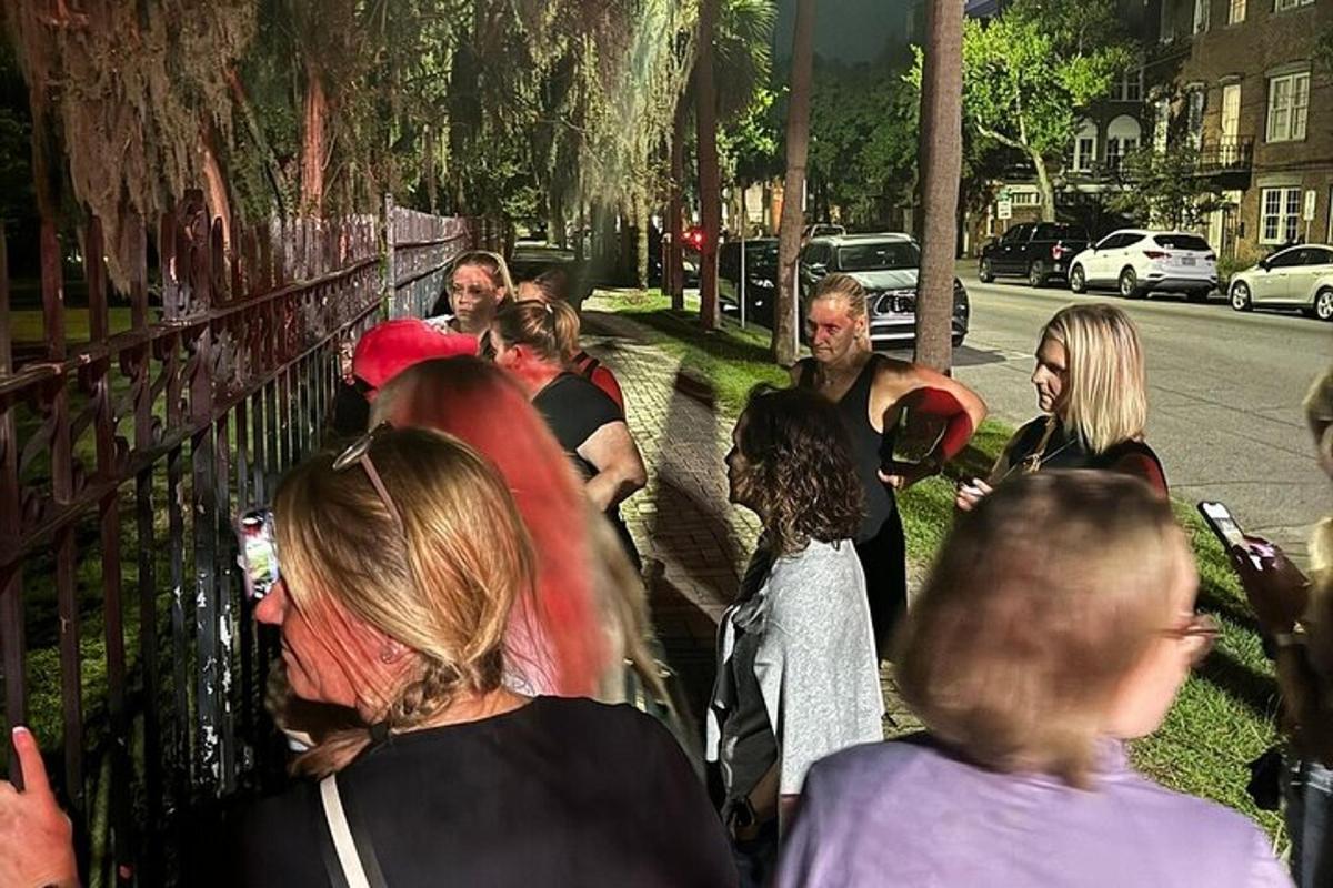 a group of people walking down a sidewalk