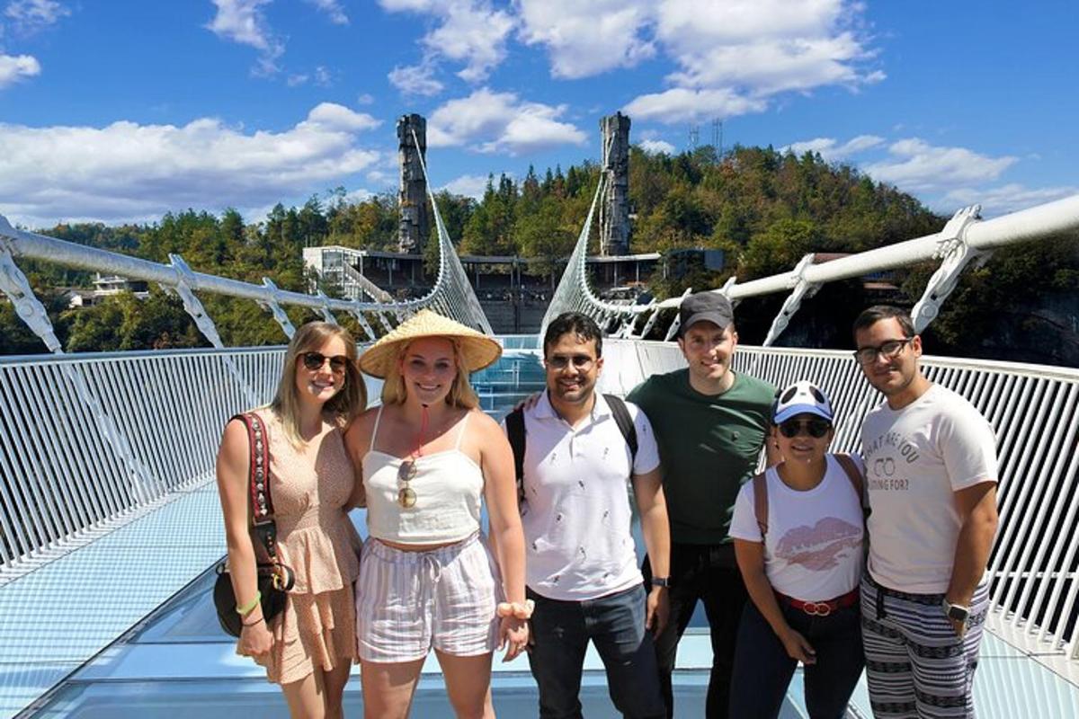 a group of people posing for a picture on a bridge