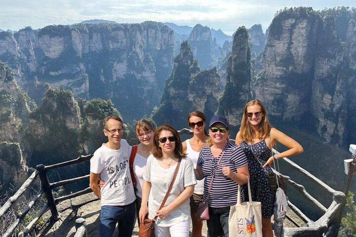 a group of women posing for a picture at the top of a mountain