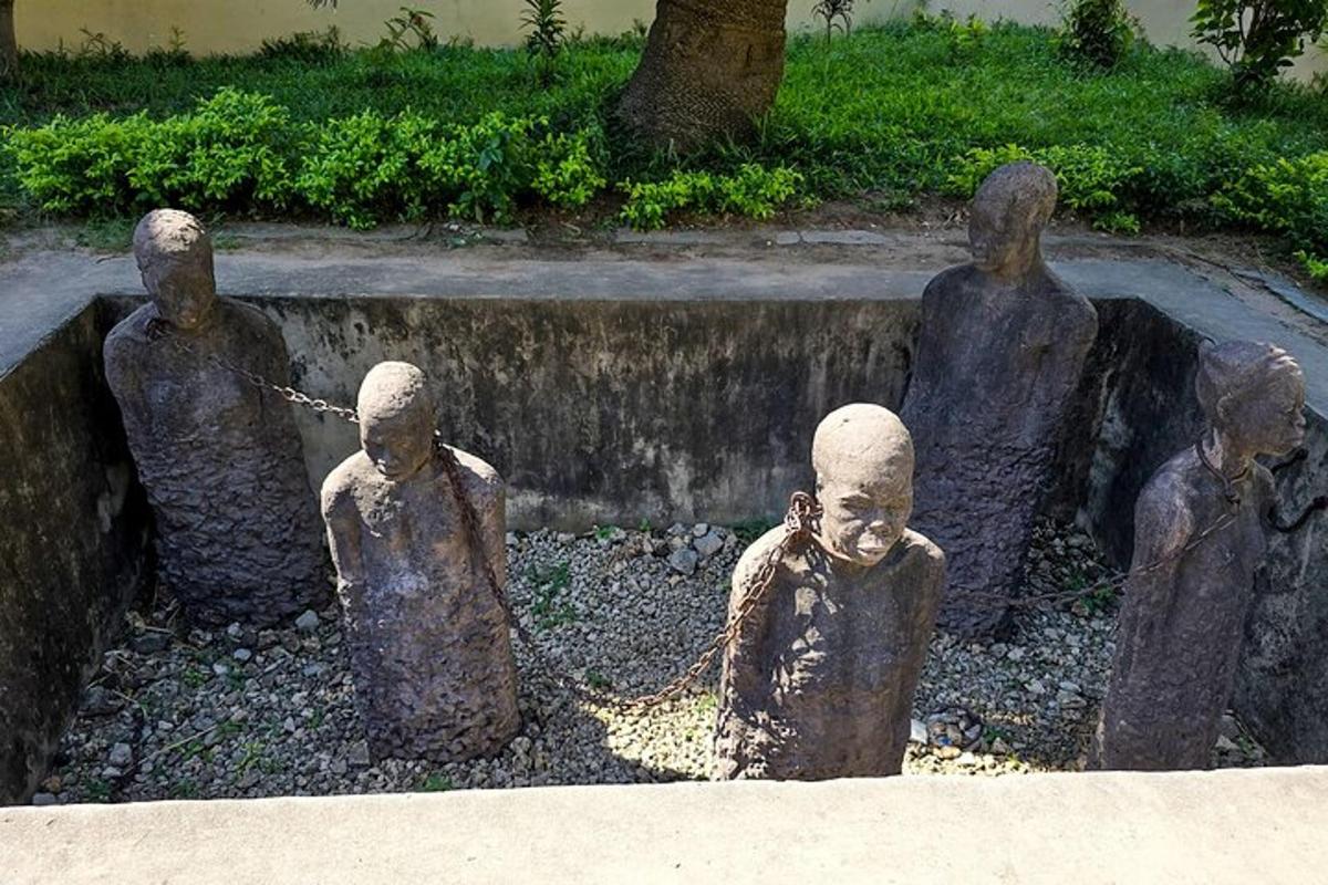 a statue of people standing next to a fountain