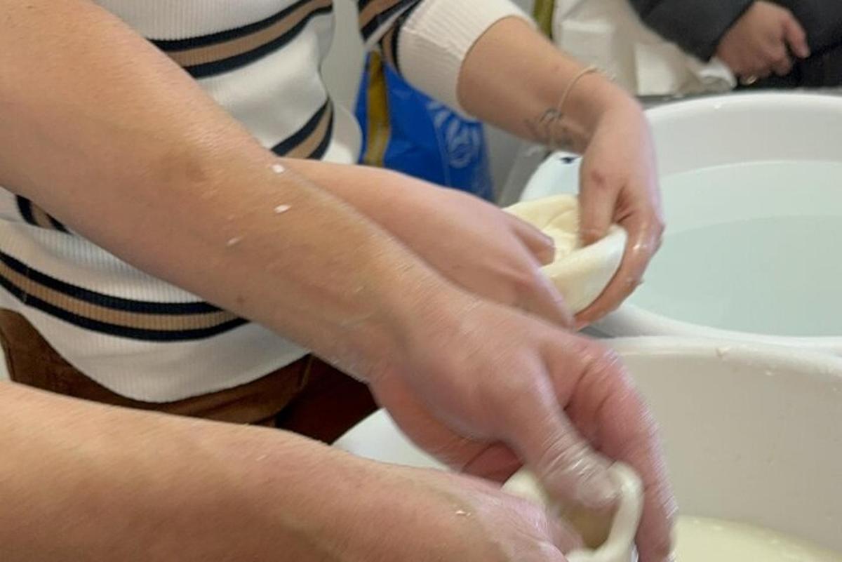 a woman is washing a bowl in a sink