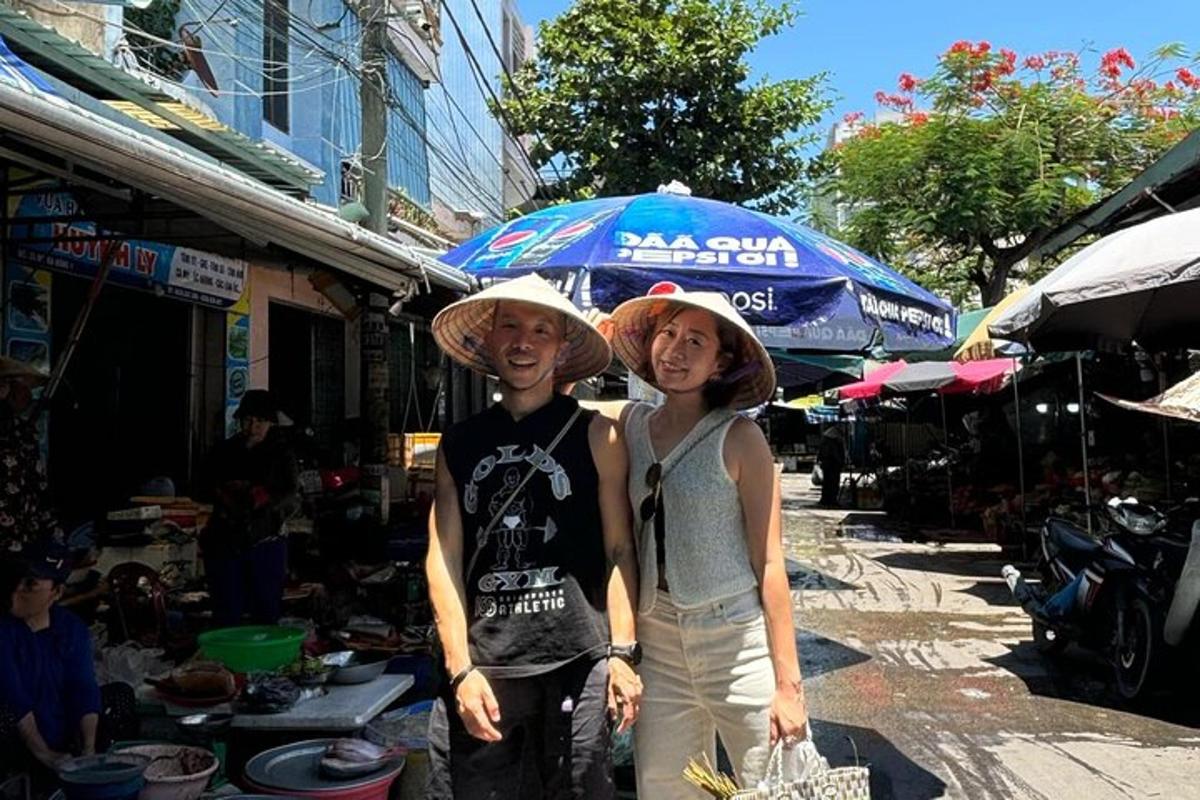 a man and woman wearing hats standing in a market
