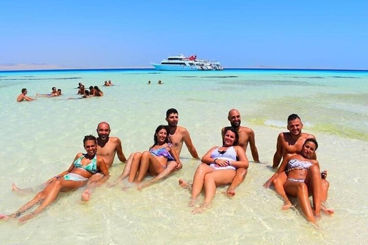 un gruppo di persone sedute sulla sabbia su una spiaggia