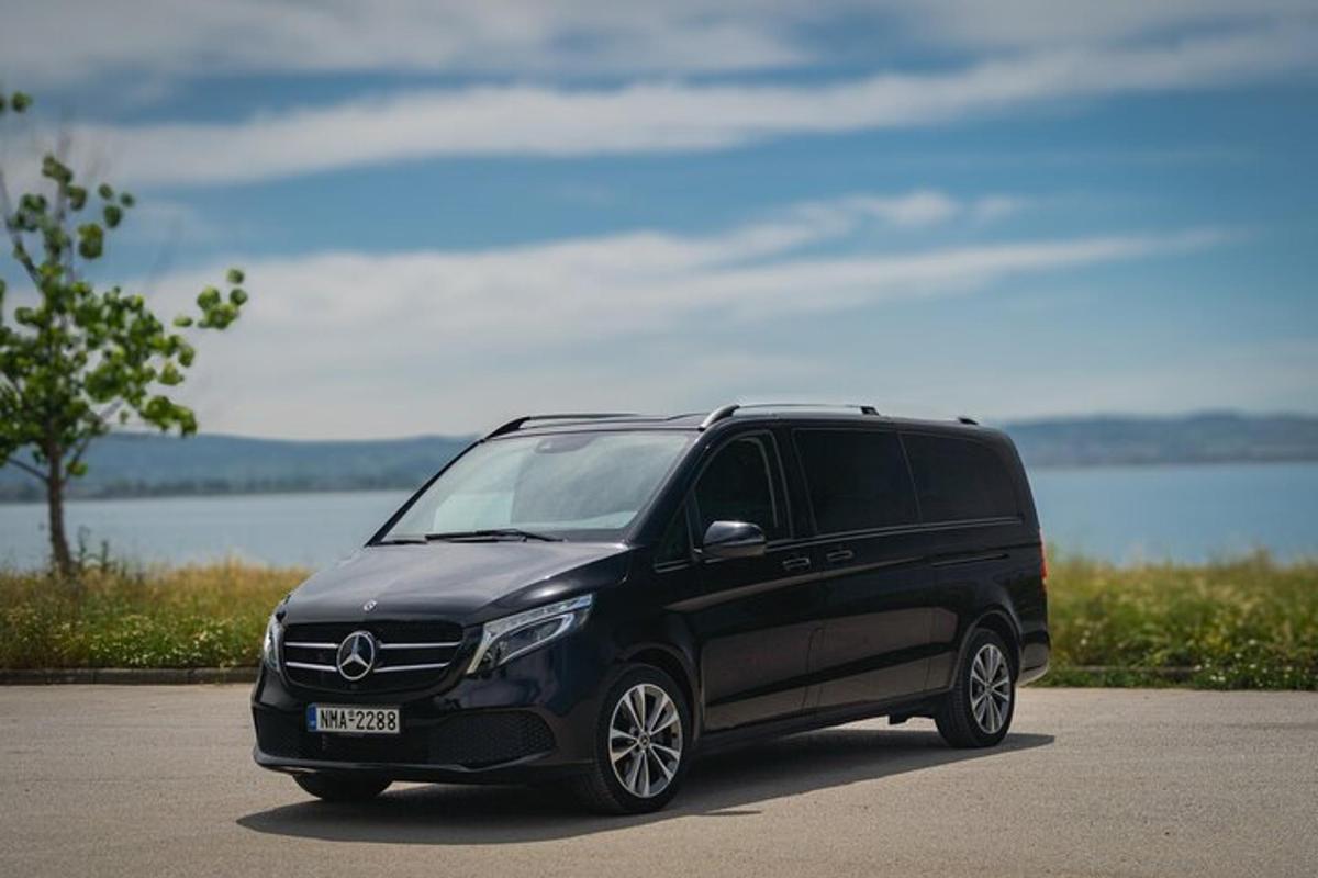 a black van parked next to a body of water