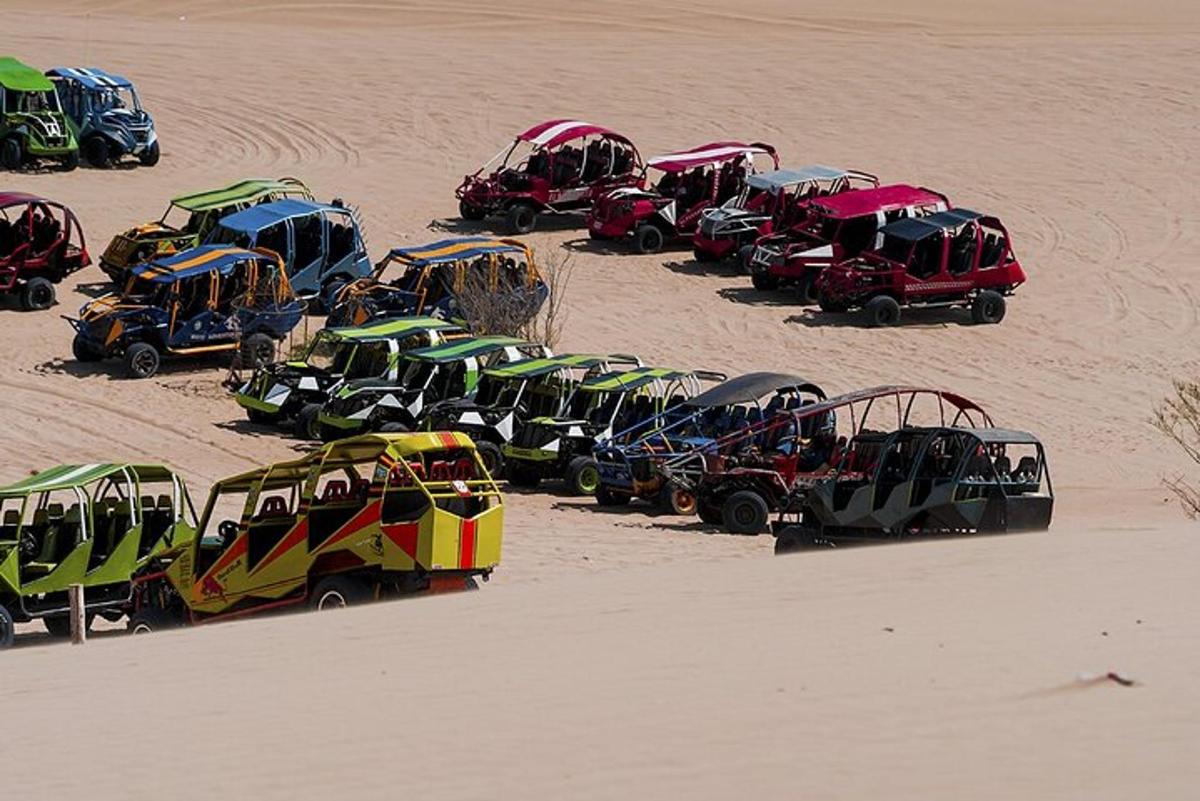 a group of cars parked in the sand