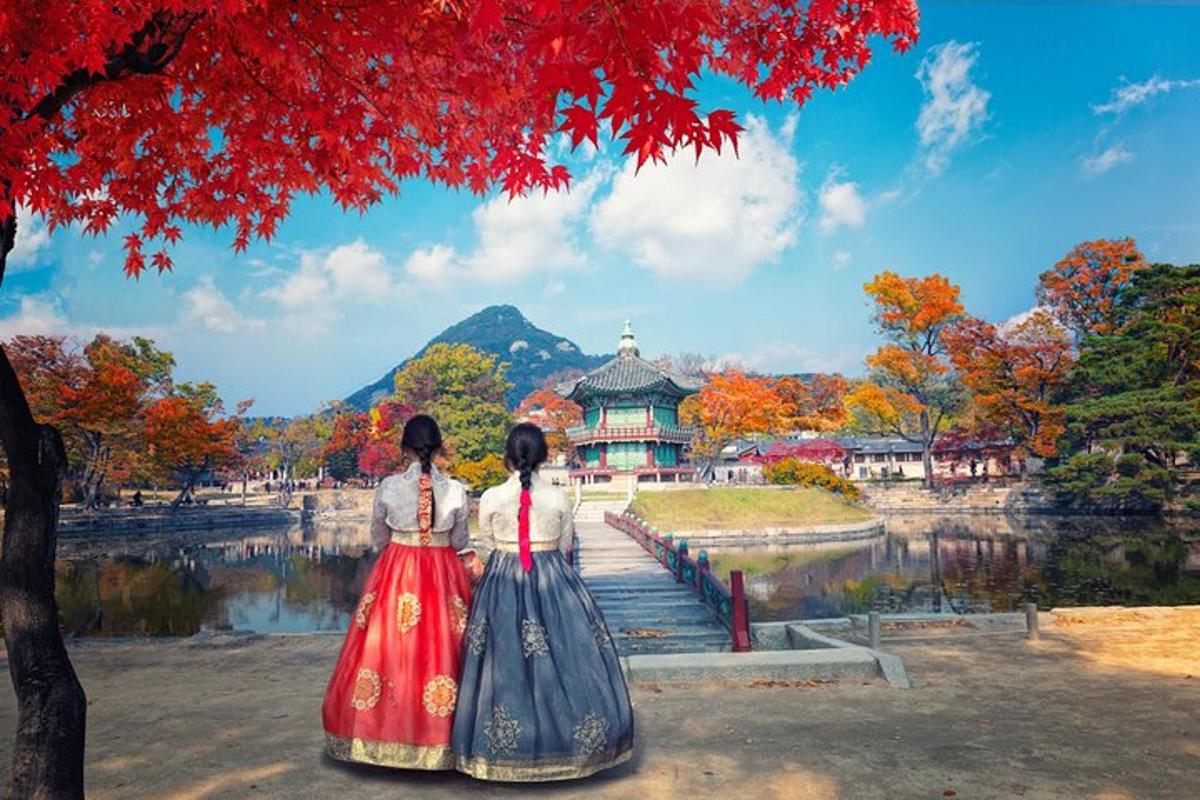 two women in traditional dress standing in front of a temple