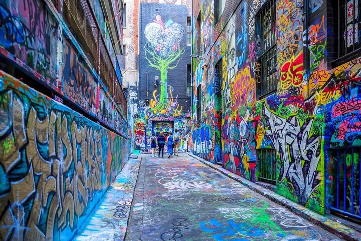 a alley covered in graffiti with people walking down it