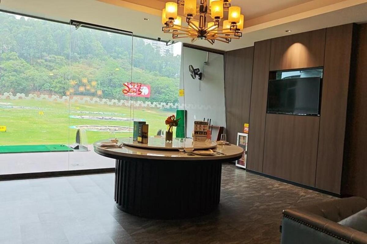 a hotel lobby with a large window and a round table