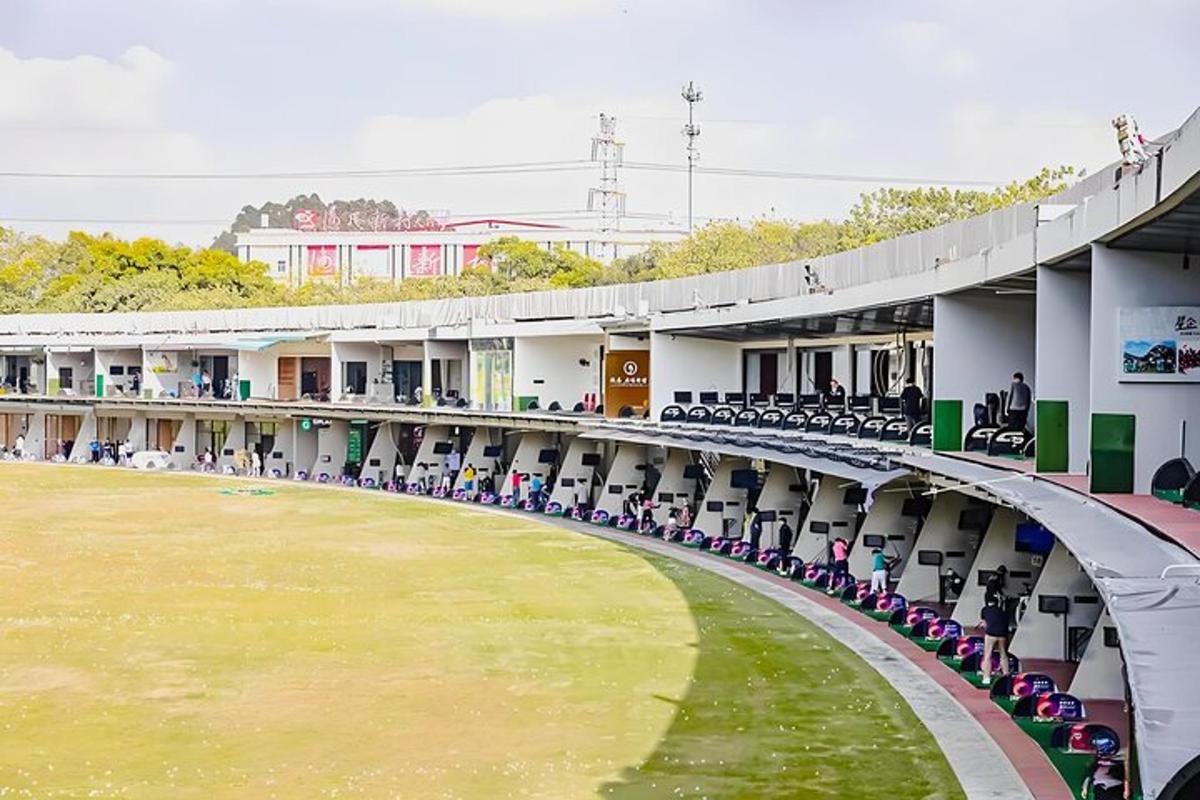 an empty stadium with chairs and a green field
