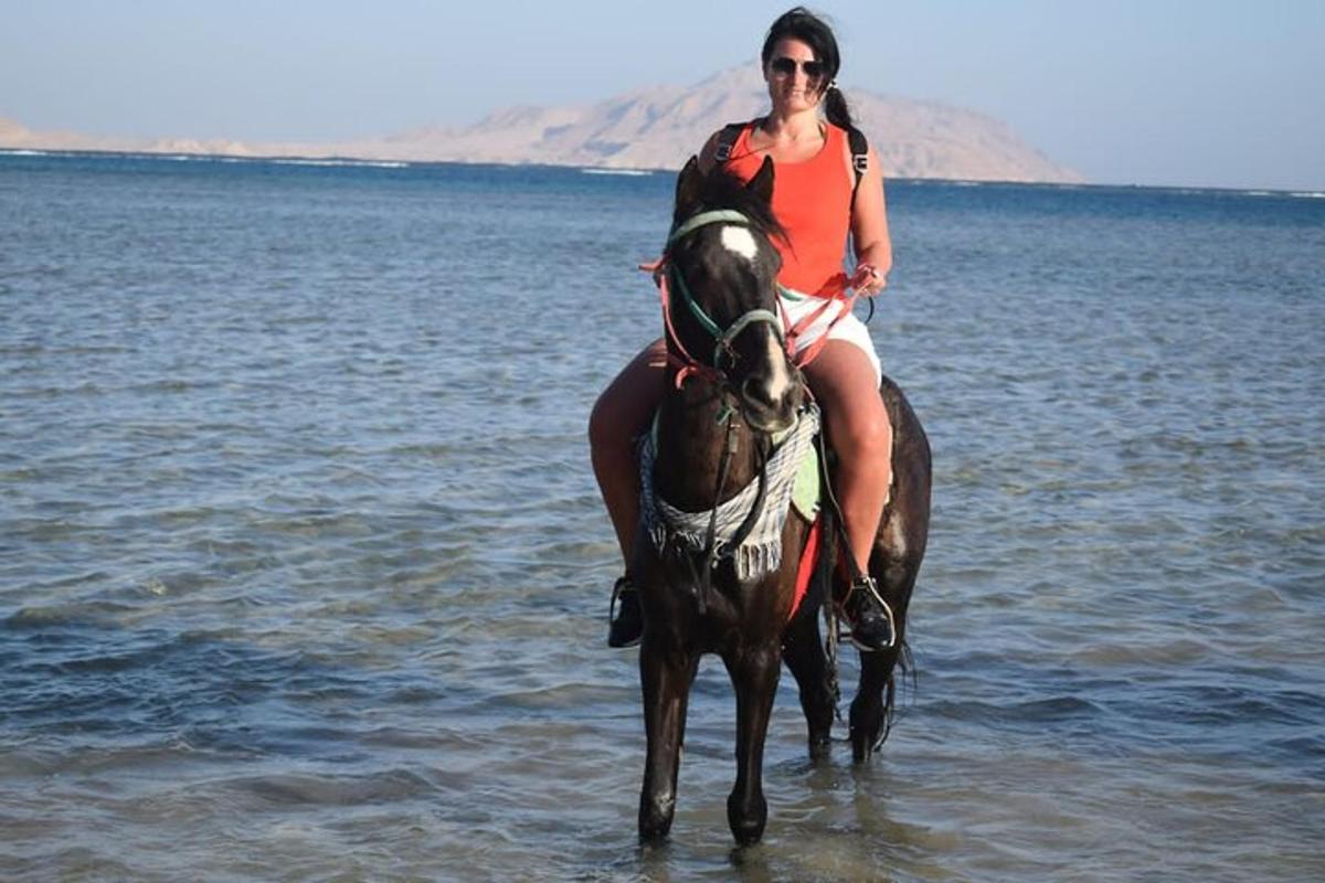 una donna a cavallo nell'acqua