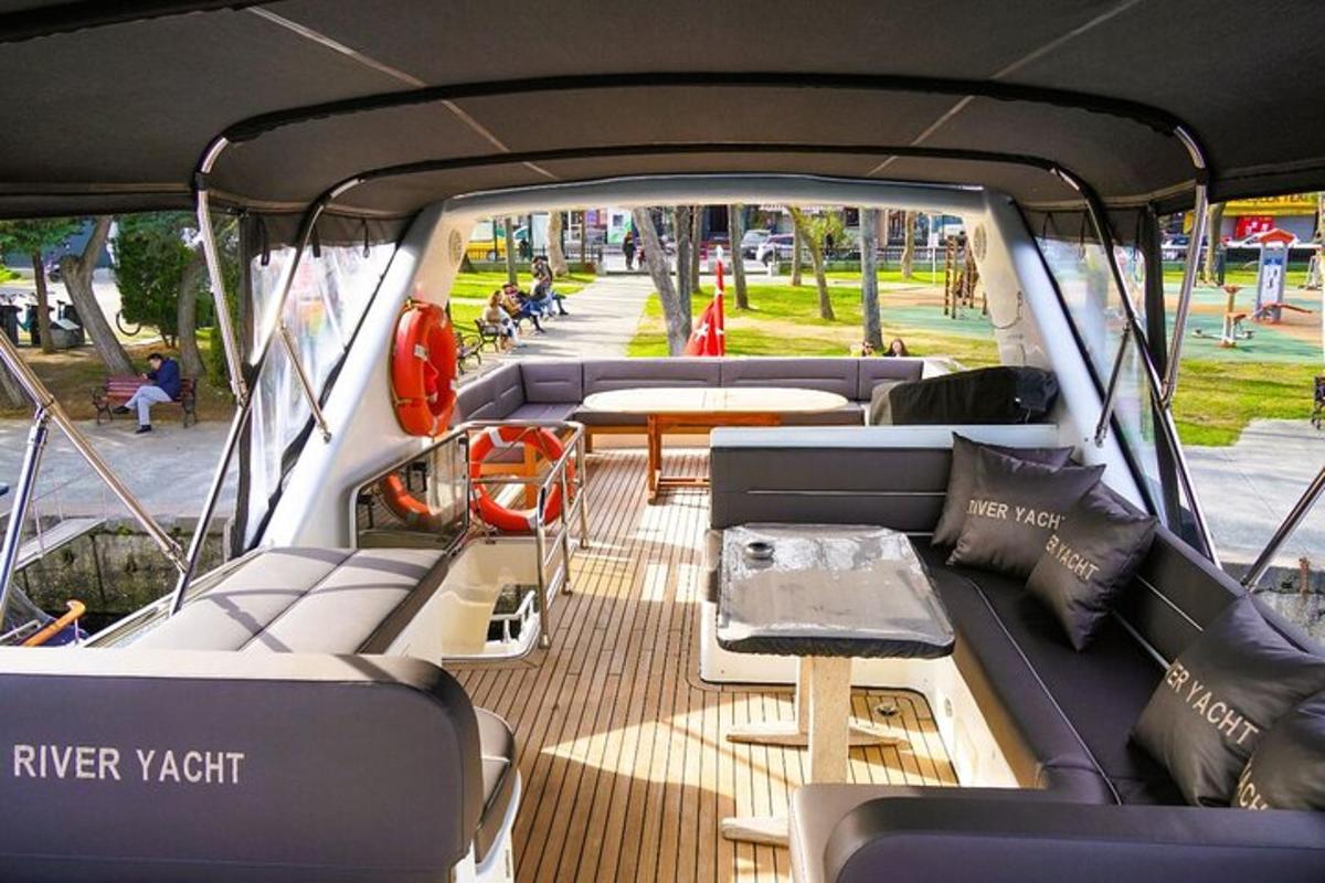 a boat with couches and tables in the back