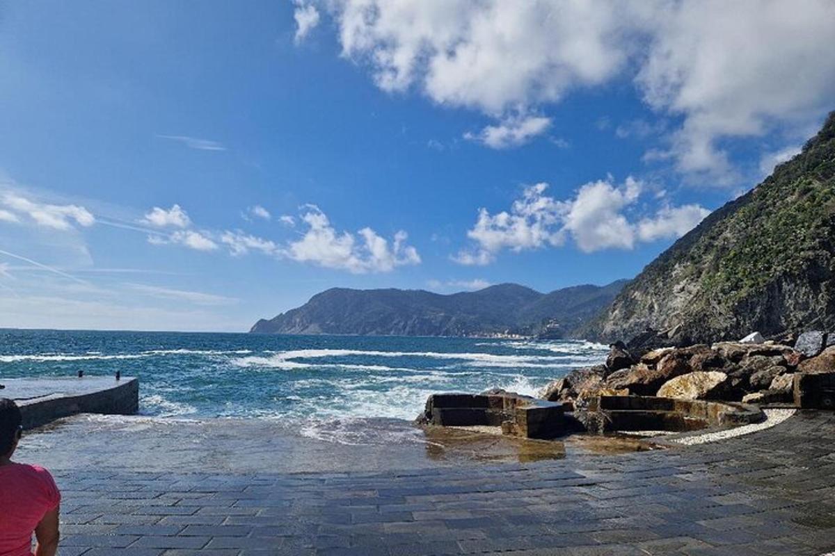 una persona in piedi su una spiaggia vicino all'oceano