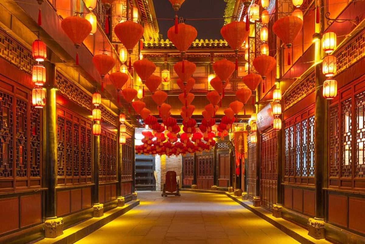 a hallway with red lanterns in a building
