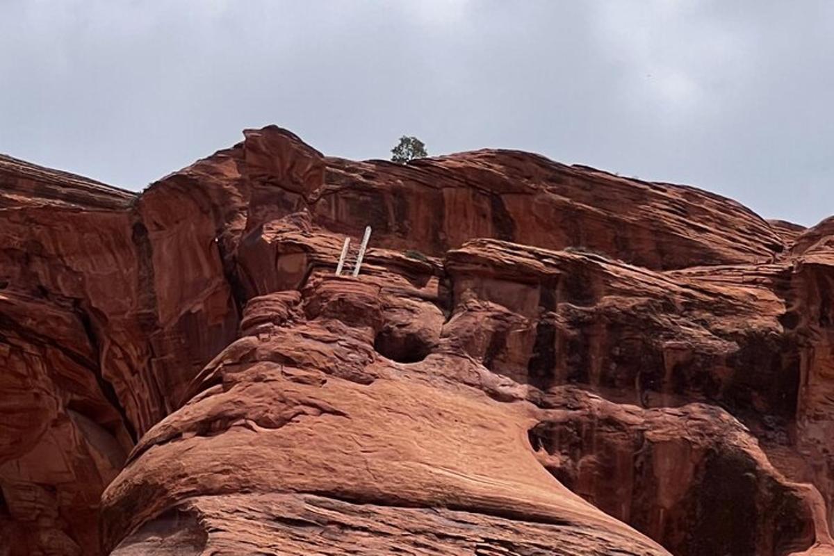 a rocky mountain with a cross on top of it