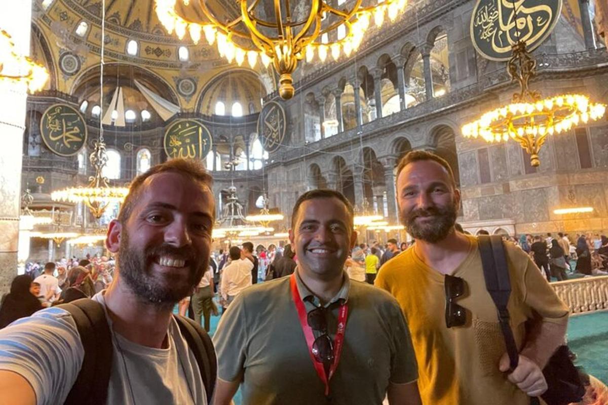 a group of three men standing in a building
