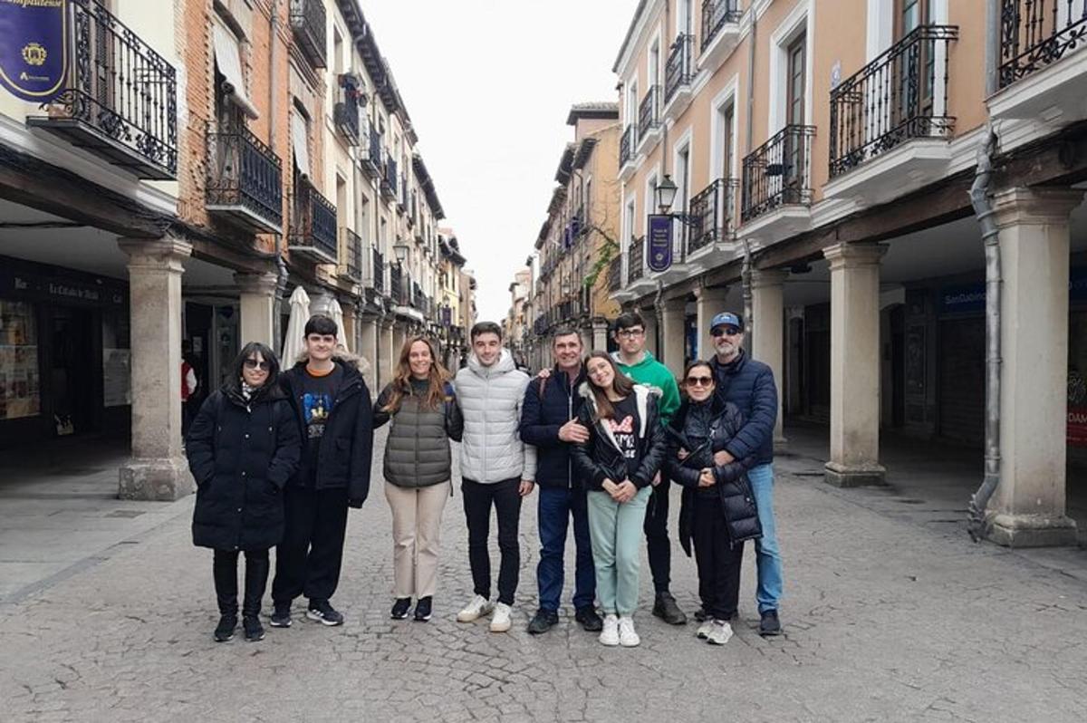 a group of people posing for a picture in a street