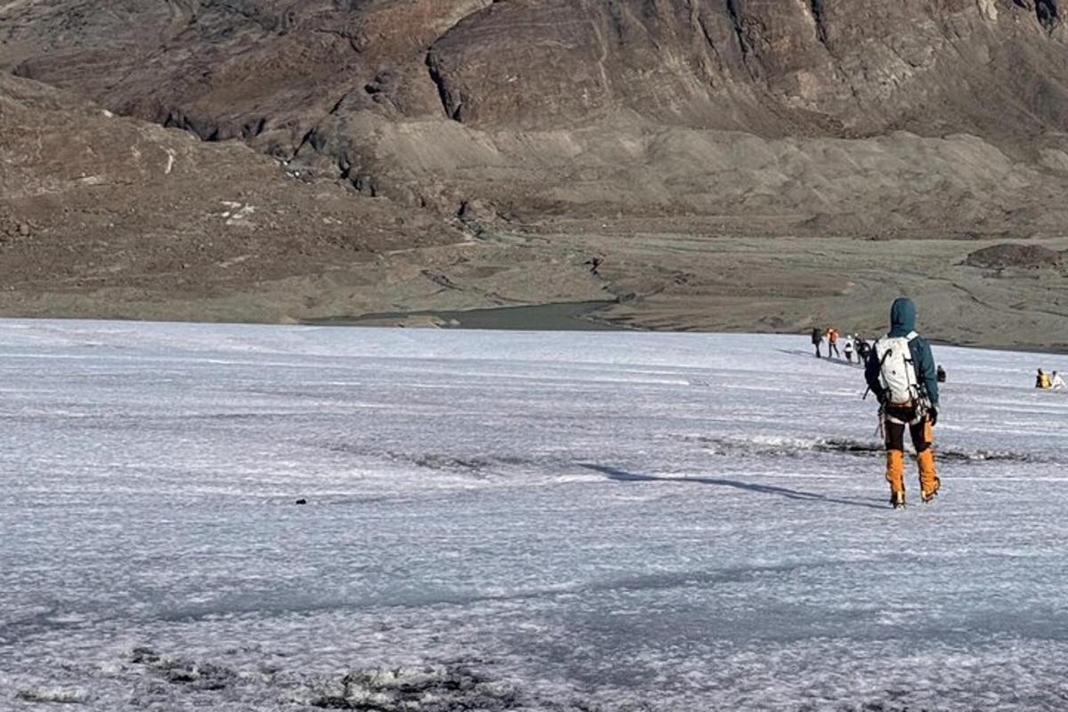 a person with a backpack walking across a body of water