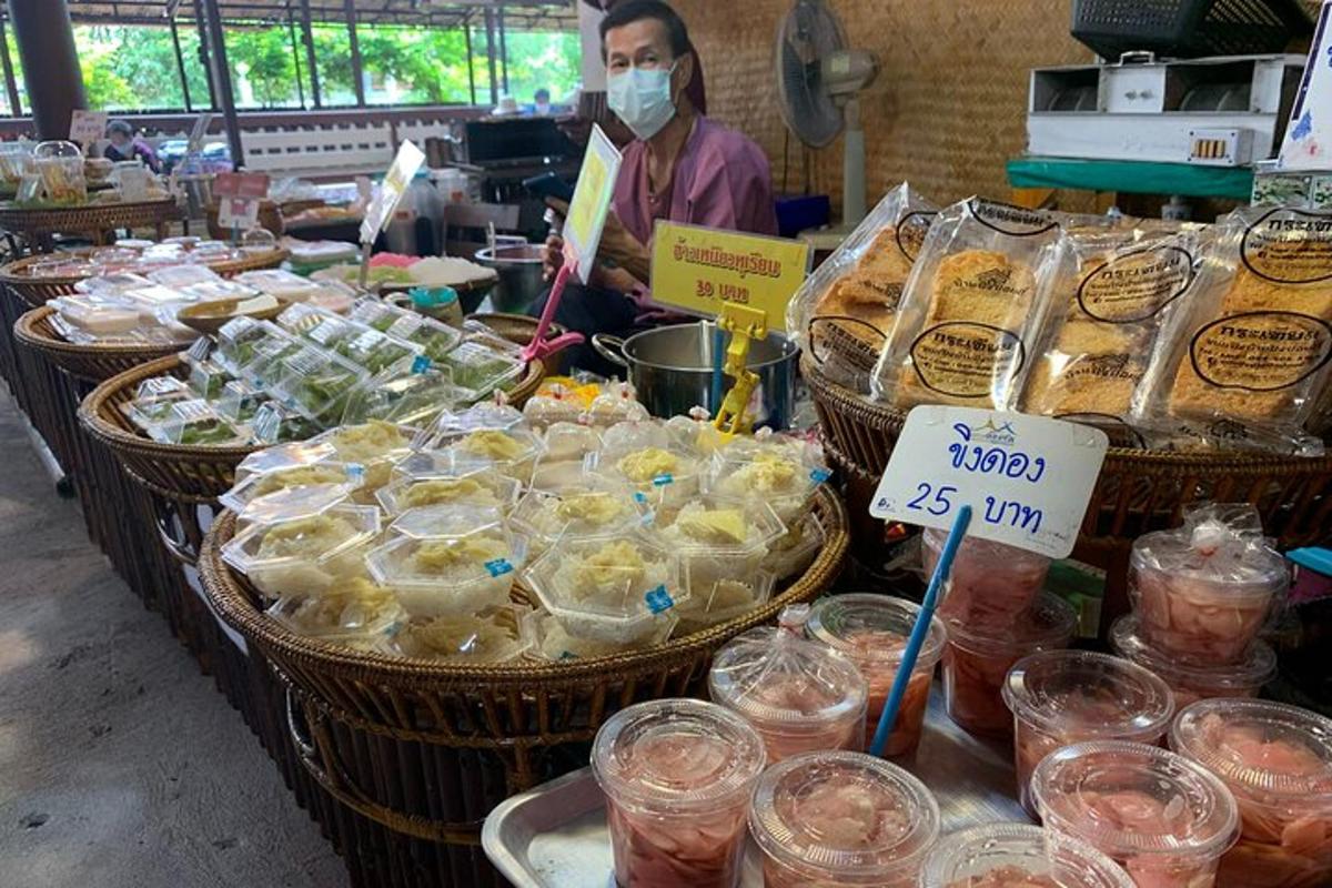 una donna che indossa una maschera in un mercato con cesti di cibo