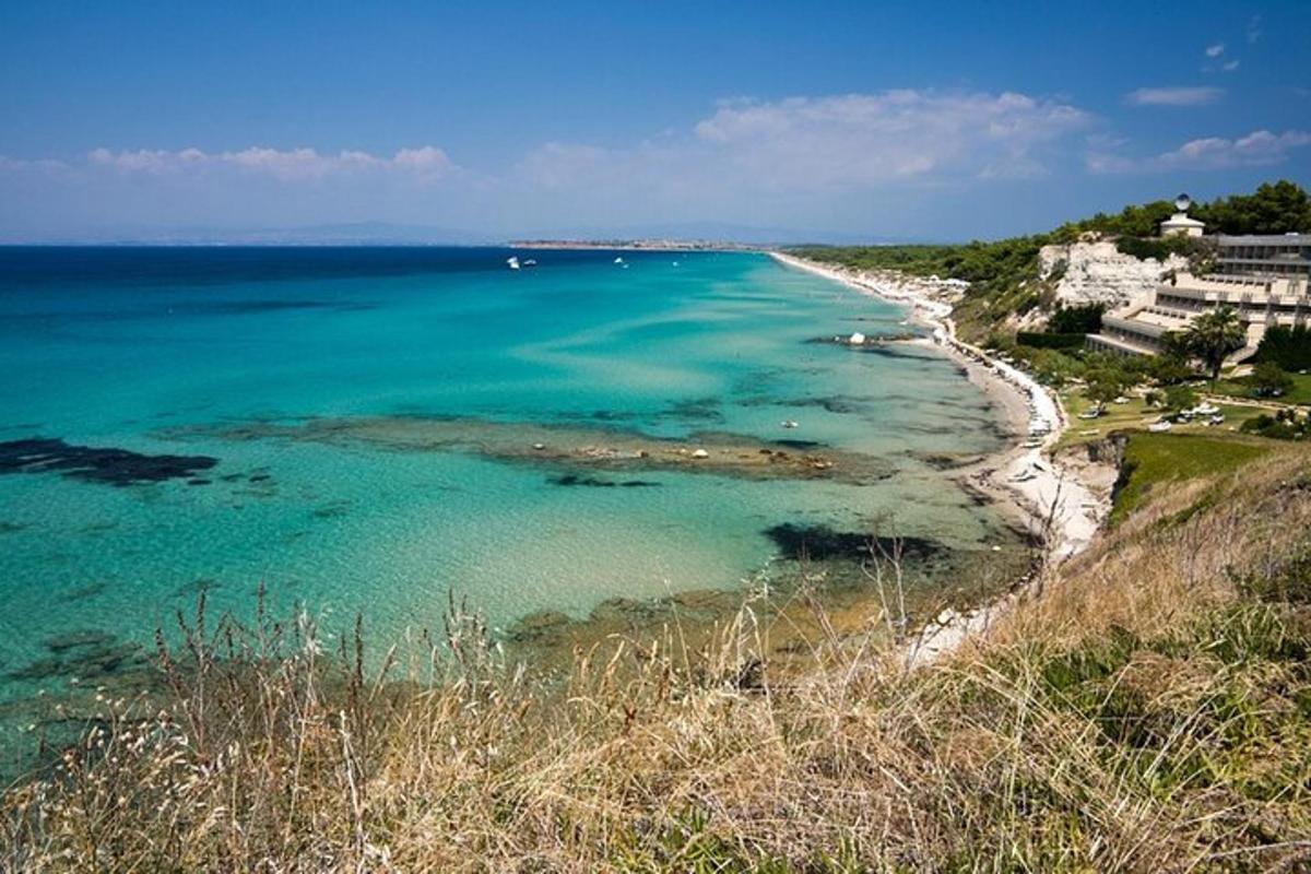 Una vista de una playa con agua azul y edificios.