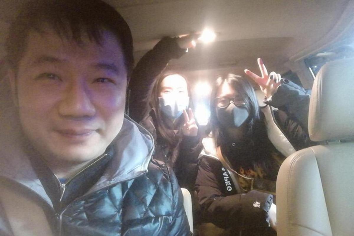 three people in a car wearing gas masks