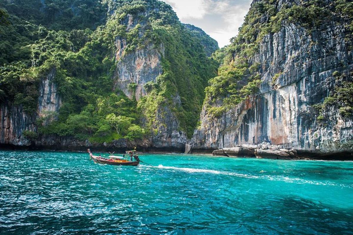 a boat in a body of water next to mountains