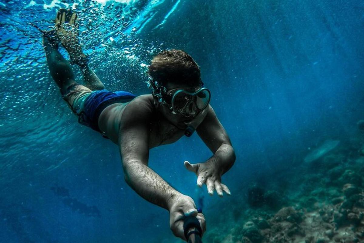 a man swimming in the water with a mask on