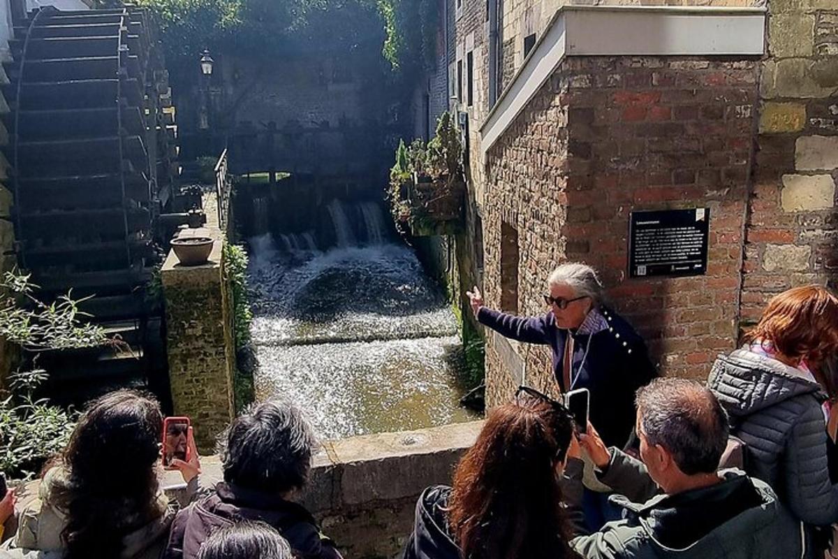 a group of people taking pictures of a waterfall