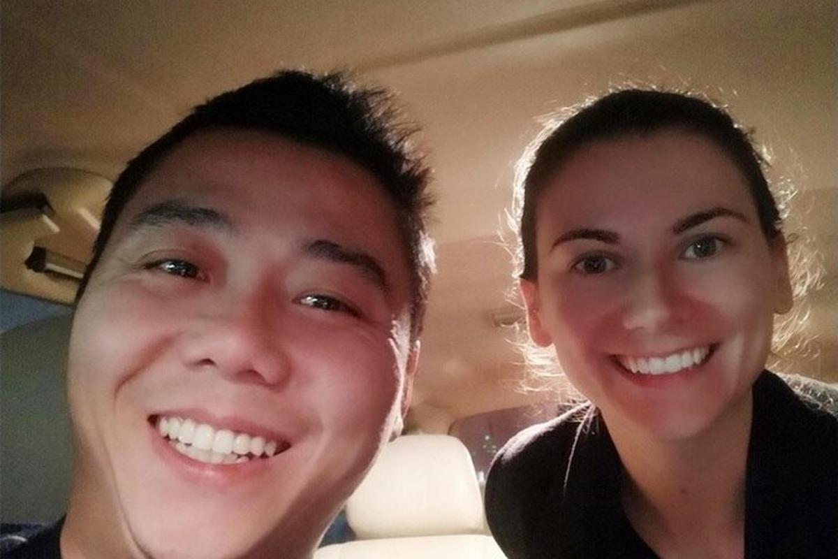 a man and a woman sitting in a car
