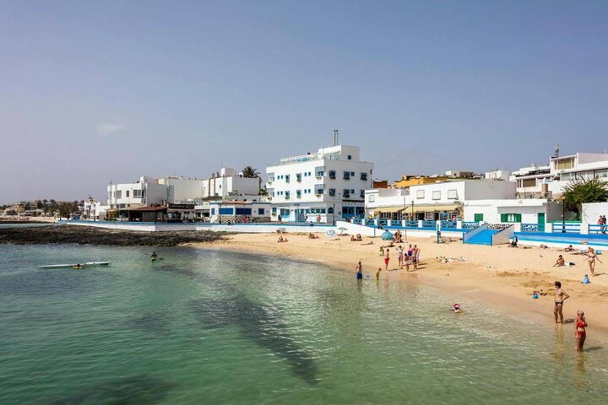 a group of people on a beach with buildings