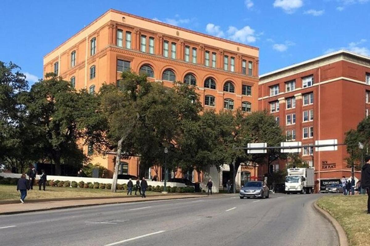 a car driving down a street in front of a building
