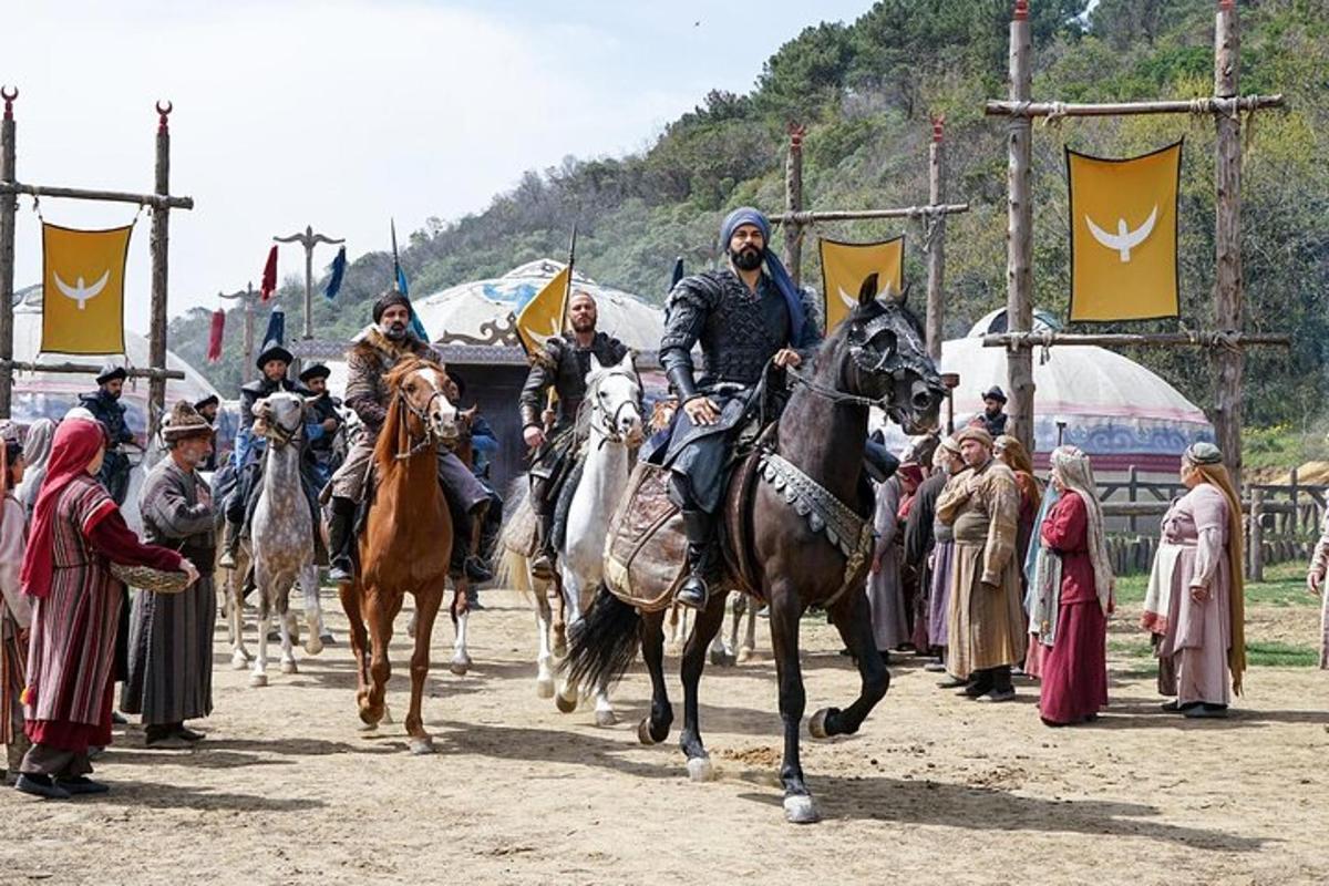 a group of men riding horses in front of a group of people