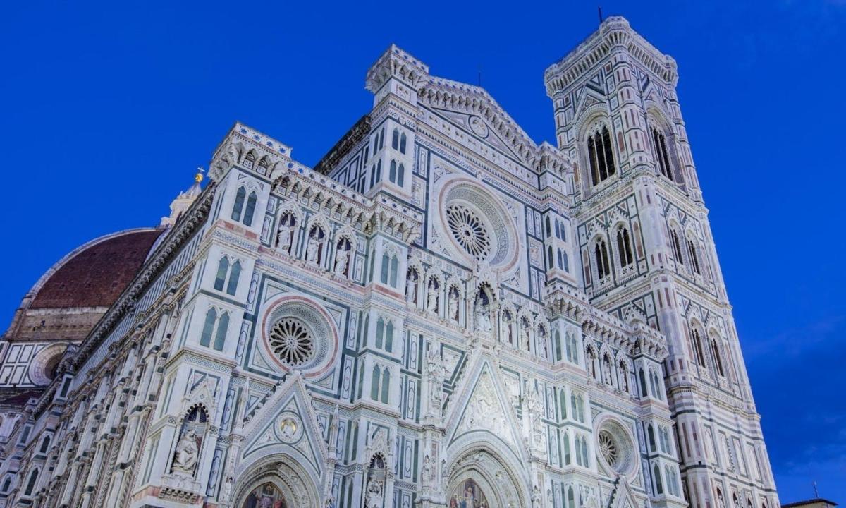 a large building with a blue sky in the background