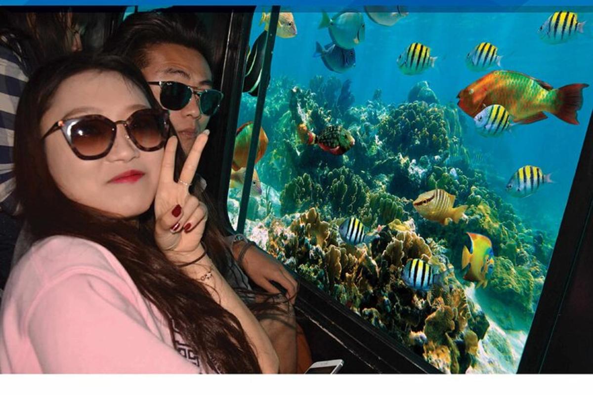 two girls in front of an aquarium with fish