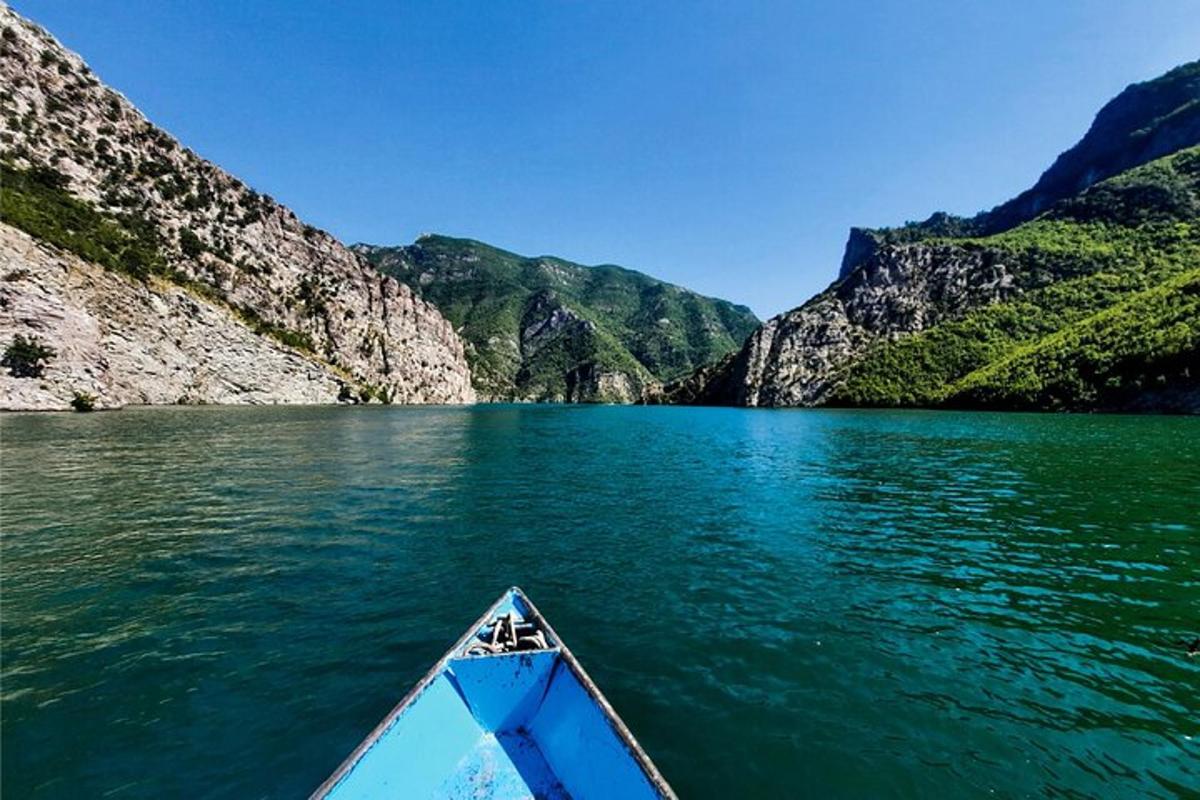 a boat on a lake in front of a mountain