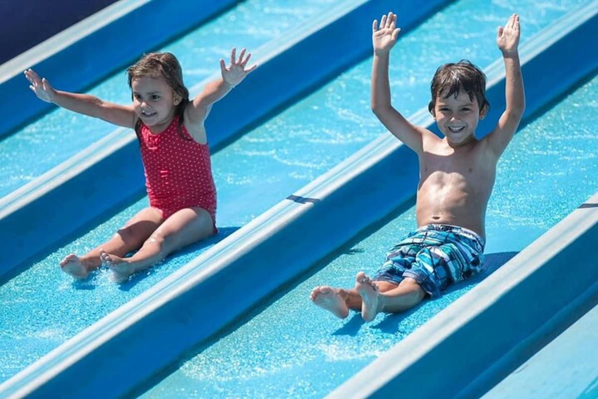 a boy and a girl on a pool of water