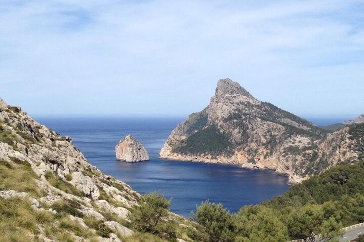an island in the ocean between two mountains