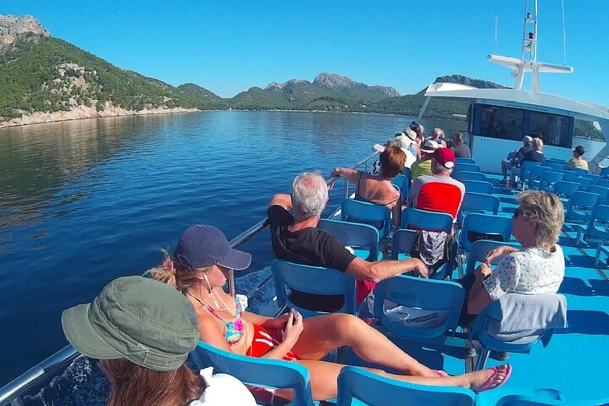 a group of people sitting on a boat on the water